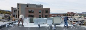 We spread the rubber roof coating with squeegies and smoothed it with rollers.