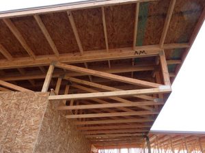 The deep truss provides more than 2 feet of space for insulation. The overhang shades the building's south wall.