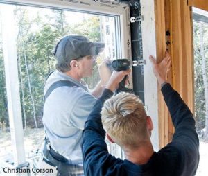 Fastening clips anchor the window to the rough opening in a block-fram window installation.